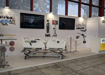 Stand Stryker all AIIC Napoli 2025. Stand medicale firmato Key Comunicazione per Stryker: esposizione di letti ospedalieri, monitor ad alta definizione e grafiche illustrative dei dispositivi medici.